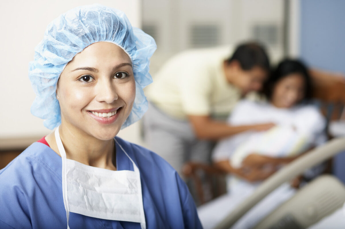 Smiling Physician near New Family --- Image by © Royalty-Free/Corbis