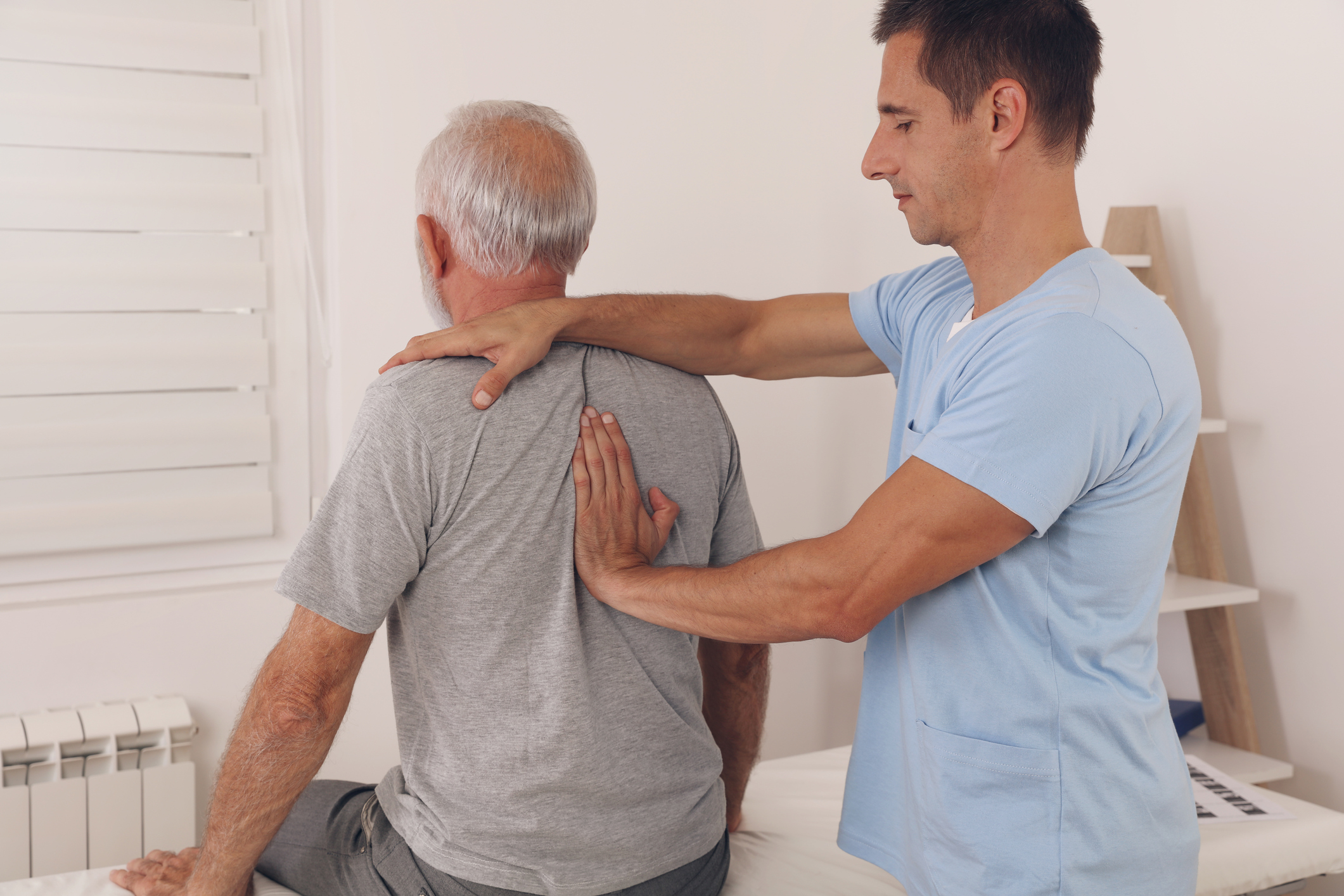 Senior man with back pain. Spine physical therapist and paient. chiropractic pain relief therapy. Age related backache