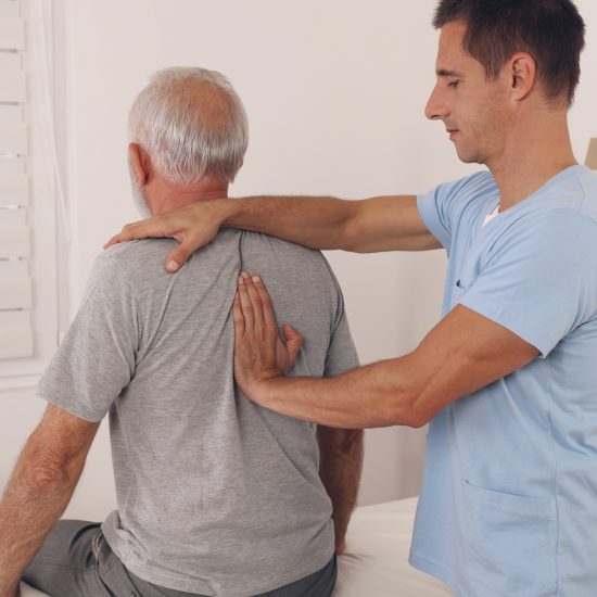 Senior man with back pain. Spine physical therapist and paient. chiropractic pain relief therapy. Age related backache